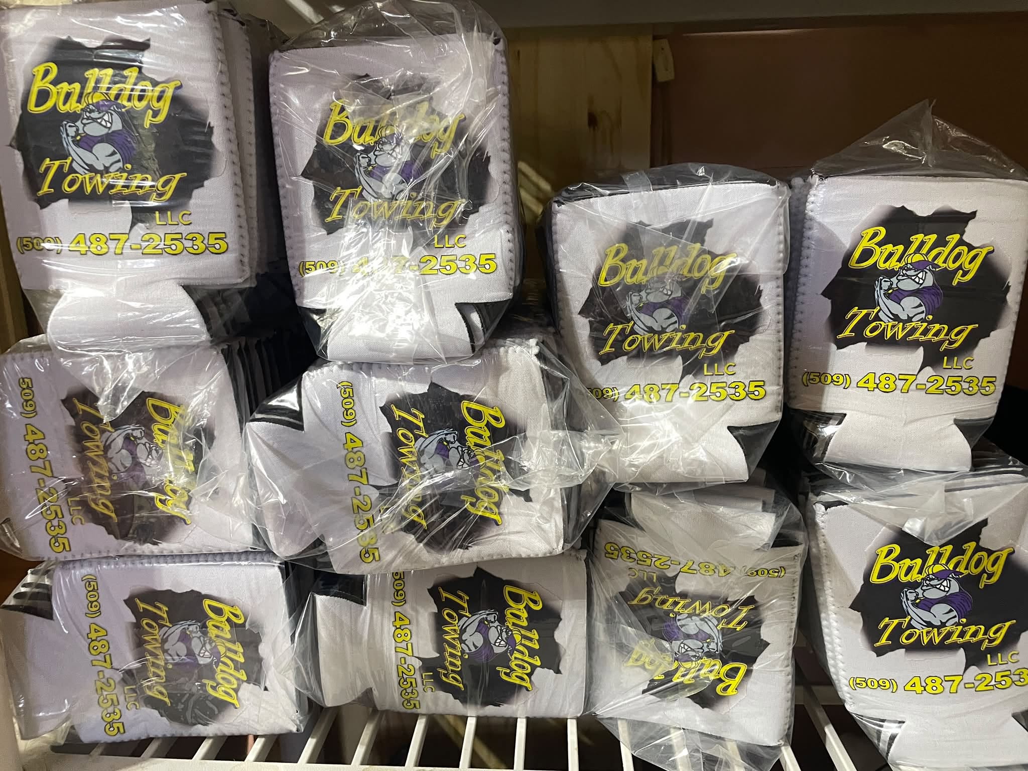 Stack of printed Bulldog Towing can coolers